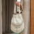 pomelli_photoshoot_image_9_16_0624 (2) Pearl Cascade Potli Bag