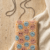 pomelli_photoshoot_image_9_16_0702 (4) Smiley Bloom Beaded Sling Pouch